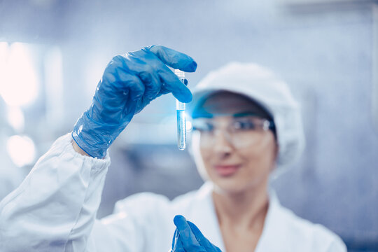 Industry scientist qc staff work checking testing quality of products water in drinking water plant production line.