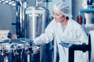 hygiene staff worker in foods and drinks clean factory. working women in water plant industry quality control check. - obrazy, fototapety, plakaty