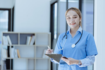 Asian female doctor with patient clipboard at hospital, Medicine and healthcare concept.