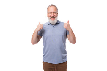 portrait of a gray-haired mature man with a beard and mustache in a t-shirt and trousers on a white background