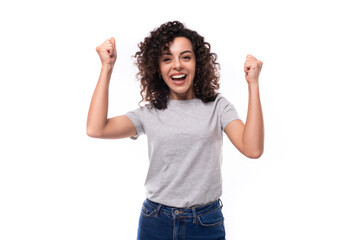 portrait of a young joyful 30 year old caucasian woman in a gray t-shirt with a mockup for printing on a white background with copy space