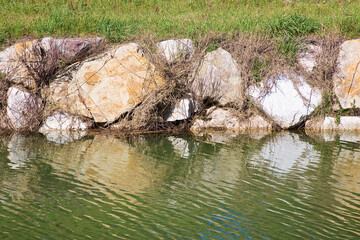 Naklejka na ściany i meble Irrigation channel with with embankments in stone blocks