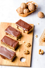 Gerbeaud Cake. Zserbo. Traditional Hungarian multi-layer cake with plum jam, nuts and covered with chocolate glaze