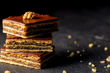Gerbeaud Cake. Zserbo. Traditional Hungarian multi-layer cake with plum jam, nuts and covered with chocolate glaze