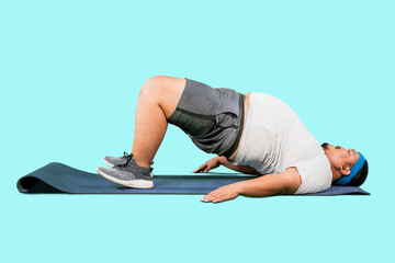 Overweight Asian guy doing some abs exercises sit up isolated on blue background