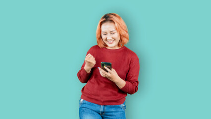 Surprised young woman reading a text message on the mobile phone