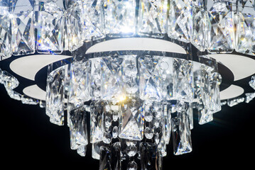 Chandelier, luxury close up crystals details on black background