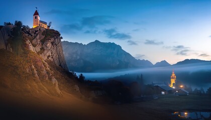 Mountains in fog with beautiful house and church at night in autumn