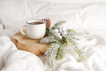 Obraz na płótnie Canvas Coffee cup with Christmas decorations on the bed. Winter holiday mood. Christmas morning, coffee time