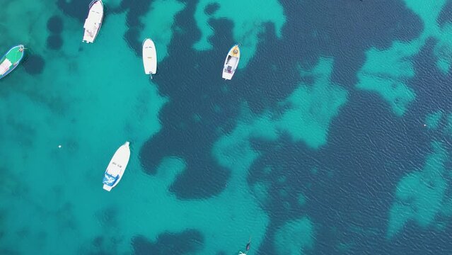 Aerial top down view to small white boats in turquoise water of the sea. Croatia coastline life