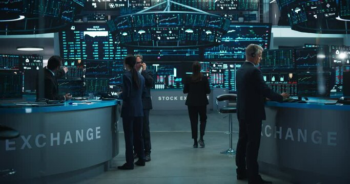 Stock Exchange Traders Working in an Office with Multiple Computer Screens with Real-Time Stocks, Commodities and Exchange Market Charts. Managers Work for Investment Banks, International Companies