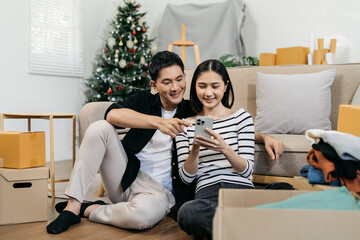 young couple helps put things in boxes and prepares, smiling happy moving to a new house.