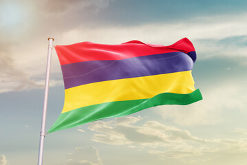 Mauritius national flag waving in beautiful sky. The symbol of the state on wavy silk fabric.