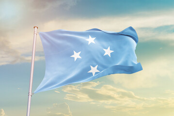 Micronesia national flag waving in beautiful sky. The symbol of the state on wavy silk fabric.