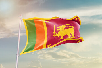 Sri Lanka national flag waving in beautiful sky. The symbol of the state on wavy silk fabric.