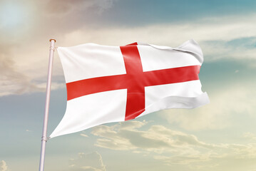 England national flag waving in beautiful sky. The symbol of the state on wavy silk fabric.