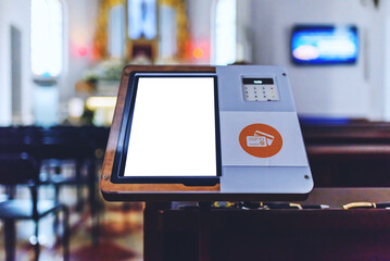 Mockup white screen.Electronic card payment terminal for church donations.A credit card reader in a church for the collect.Copy space. - obrazy, fototapety, plakaty