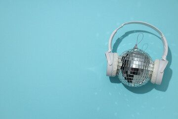 A beautiful disco ball with headphones on a blue background