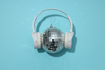 A beautiful disco ball with headphones on a blue background