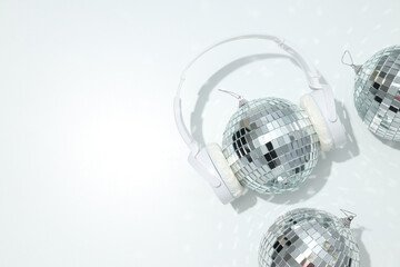A beautiful disco ball with headphones on a light background