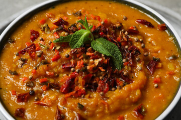 Sweet potato puree with spices in bowl on gray background, close up