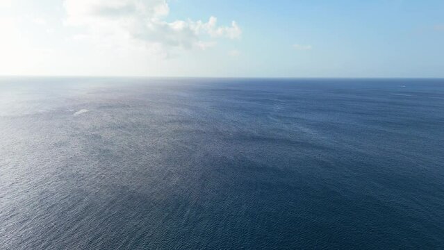 High angle overview of empty ocean sea as wind blows waves across surface, view to horizon