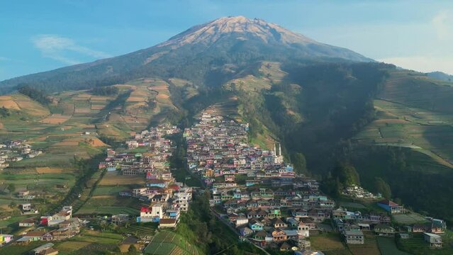Aerial of Nepal Van Java tiered colourful village on slope of active volcano.