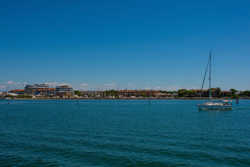 The coastal holiday resort town of Grado in Friuli-Venezia Giulia, north east Italy. Viewed from the Marano and Grado Lagoon in August