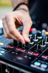 DJ Hands creating and regulating music on dj console mixer in concert