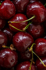 Cherry background.Close up of a bunch of bright red cherries shot from above. Cherry with drops. Food background.