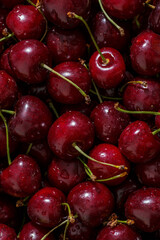 Cherry background.Close up of a bunch of bright red cherries shot from above. Cherry with drops. Food background.