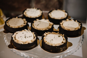 Pastries with cream and nuts on plate. Delicious reception luxury ceremony. Candy bar on wedding...