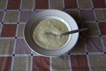 Plate of semolina porrige on the table