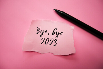 Bye, bye 2023 in a torn paper note with black pen.