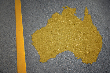 yellow map of australia country on asphalt road near yellow line. concept