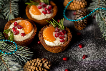 Christmas nut tartlets. Delicious, beautiful cupcakes are decorated with Christmas garlands and Christmas tree branches. Selective focus