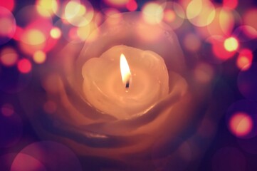Burning candle with bokeh light in black background. Burning candles over black background with...