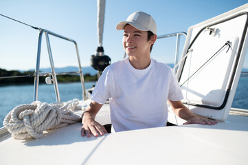 Smiling teen on a yacht looking contented