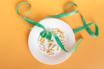 Weight Loss Pills and Measuring Tape, Diet Supplements Capsules, Obesity Lose Tablets, Color Drugs Pile