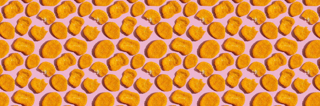 Seamless pattern with chicken nuggets on pink background. Food banner.