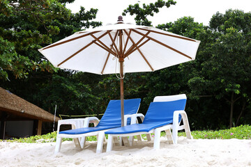 Sandy beach with parasol and deck chairs. Tourist resort on sea coast