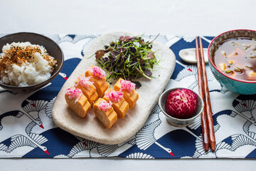 Japanese breakfast: egg roll tamagoyaki, miso soup, herb salad and rice