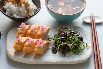 Japanese breakfast: egg roll tamagoyaki, herb salad and rice
