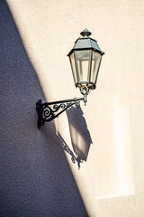 Vintage street lamp on the wall with deep shadows