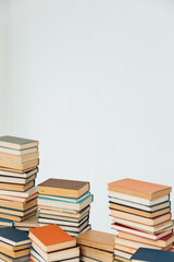 Lots of stacks of old educational books on white background university school library