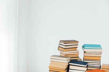 Lots of stacks of old educational books on white background university school library