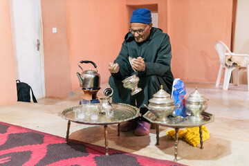 Fototapeta na wymiar Man pouring water from kettle while making tea