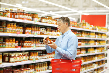 elderly man choosing groceries in a supermarket