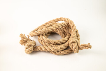 Twisted thick rope with knots at the ends on a white background
