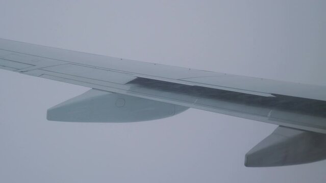 Turbulent Flight with Snow and Rain: Adverse Weather Conditions During Air Travel in 4k slow motion 60fps